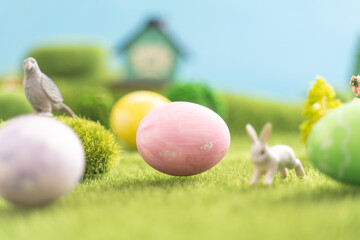 In the middle of a vast grassy field, there sits a pink easter egg