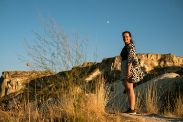 Beautiful woman smiling at a beautiful sunset in Cappadocia
