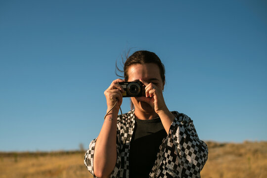Smiling woman holding a digital camera in Cappadocia