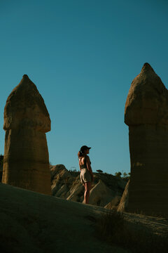 Serene woman standing among geological formations in Cappadocia