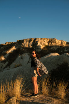 Beautiful woman smiling at a beautiful sunset in Cappadocia