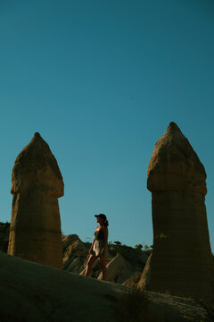 Serene woman standing among geological formations in Cappadocia
