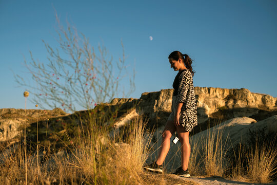 Serene woman walking at sunset in Cappadocia