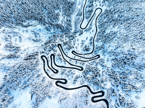 Maloja pass road in the snowy woods, Switzerland