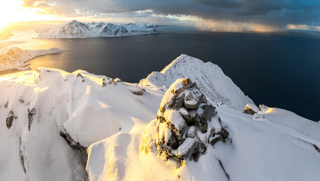 Snowy peaks overlooking a fjord at dawn