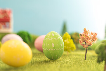 In the middle of a vast grassy field, there sits a pink easter egg