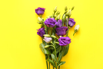 Bouquet of beautiful eustoma flowers on yellow background, closeup