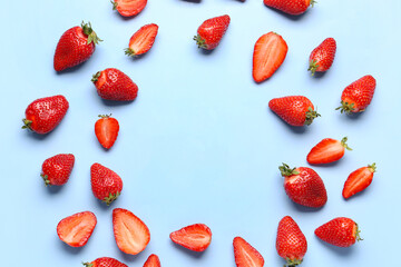 Frame made of fresh strawberries on blue background