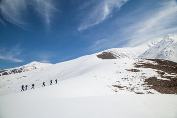 A group of ski tourers ascends Mt. Ishkhanasar in Syunik, Armenia, a mountainous border region now...