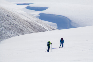 A group of tourists skiing through Armenia’s mountains during late spring. The untouched snow and...