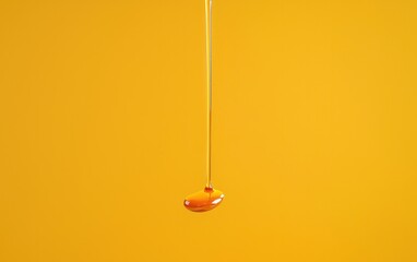 A single slice of mango sits on a vibrant orange textured fabric. The mango is sprinkled with iridescent glitter, catching the light against a dark background