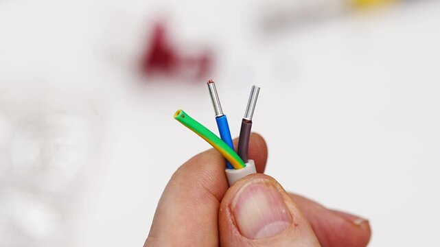 Master repairs household appliances by crimping a terminal on electrical wire