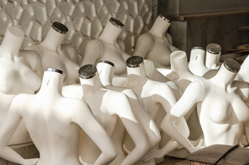 lots of headless plastic mannequins in the store's warehouse
