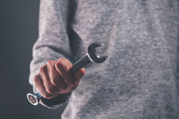 male hand holds a key on a black background. key to the keys