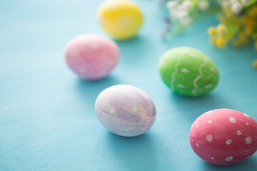 Colorful easter decoration with and flowers on gray wooden table. Top view