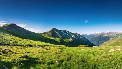Fototapeta premium vibrant natural landscape with green grass mountains and clear blue sky perfect for outdoor themes