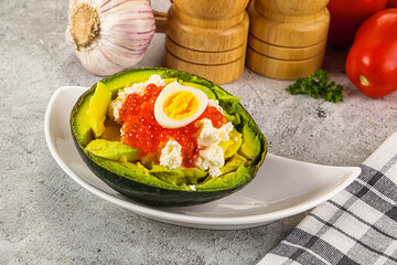 Avocado with red caviar and quil egg