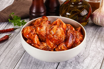 Raw marinated buffalo chicken wings