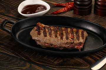 Grilled beef striploin steak with sauce