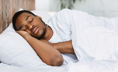 Asleep African American Guy Sleeping Resting Peacefully In His Comfortable Bed At Home, Lying With...