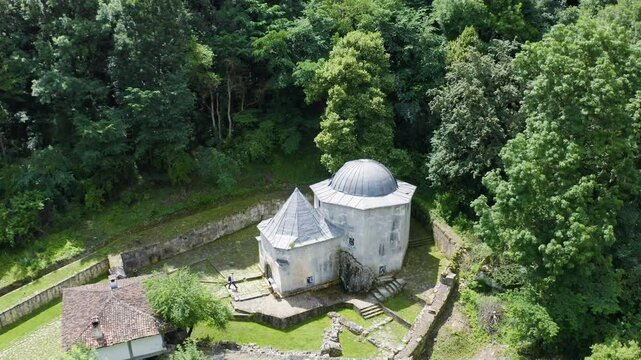 Circular drone shot above Demir Baba Teke, showing a dome-shaped structure in Razgrad province in Bulgaria.