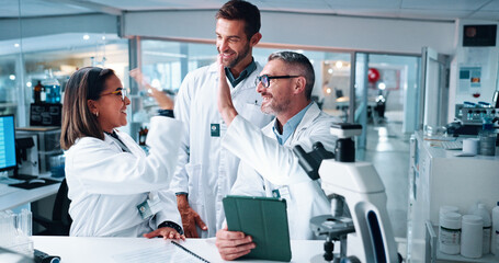 High five, science and success with people in laboratory together for breakthrough or development. Tablet, microscope and motivation with research team in clinical trial for celebration or target