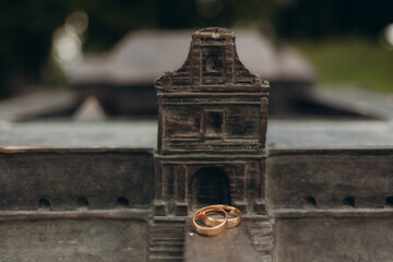 Golden Wedding Rings on Historical Monument with Intricate Details