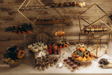 Elegant Dessert Table Display Featuring Fruits, Pastries, and Luxurious Golden Decor