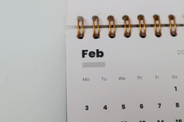 Closeup of February calendar on white table