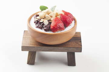 Patbingsu is a food made by crushing ice into small pieces and adding boiled red beans or sugar.