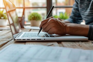 Close-up: Businessman filling out online survey form on laptop in office