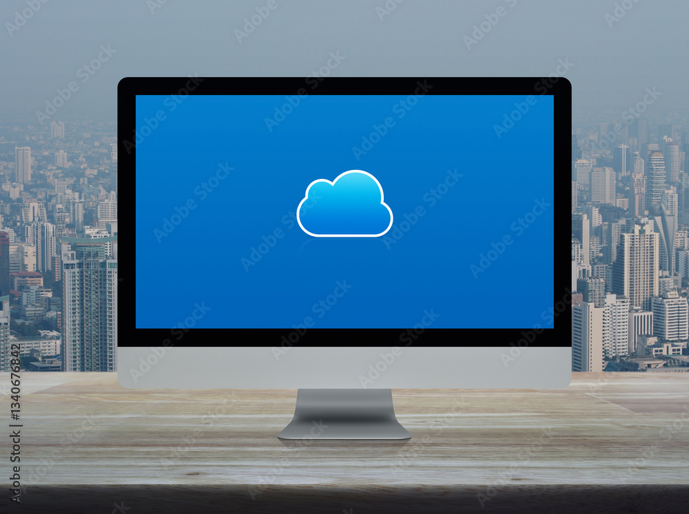 Poster cloud computing icon on desktop modern computer monitor screen on wooden table over office building 
