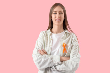 Beautiful young happy woman with ribbon on pink background. Multiple Sclerosis Awareness Month
