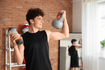 Sporty young man with protein shake and kettlebell in gym