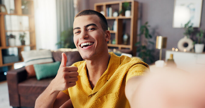 Happy, thumbs up and selfie portrait of man in home for social media, online post and profile picture. Smile, influencer and person with gesture for approve, yes and like emoji in living room