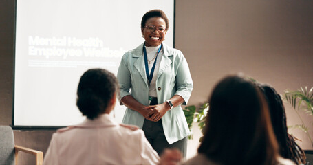 Happy woman, presentation and meeting with group for mental health program or employee wellbeing at...