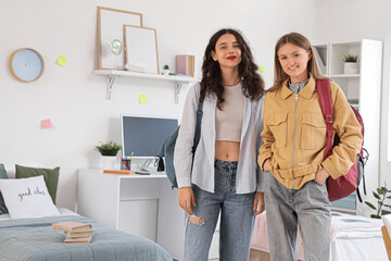 Female students with backpacks in dorm room