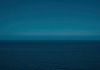 Obraz premium Calm sea view with rippled surface. Marine blue horizon background for peaceful seascape design. Nature travel backdrop with deep ocean for elegant vacation themes.