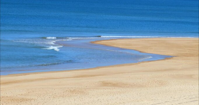 Waves sculpting the Atlantic Ocean and the beach