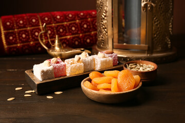 Turkish delight and dried apricots on wooden table, closeup. Ramadan celebration