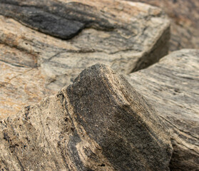 A rock with a rough surface and a few cracks