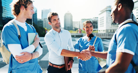 Medical students, happy people and shaking hands for support, agreement or residency completion....