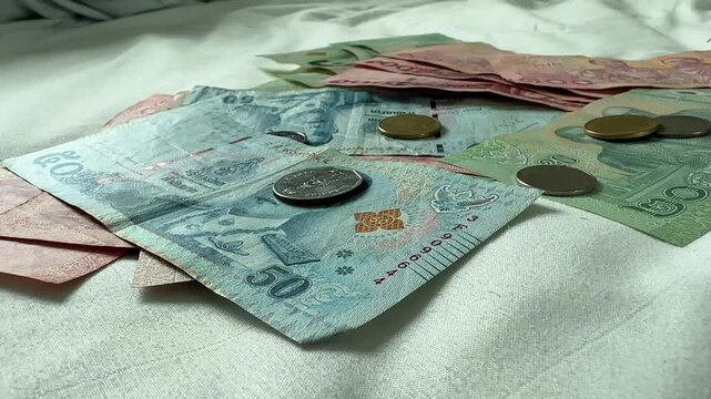 Close up of Thai Baht currency bills notes coins THB Thailand money cash