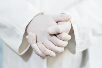 Close-up of a doctor's hands in sterile rubber gloves