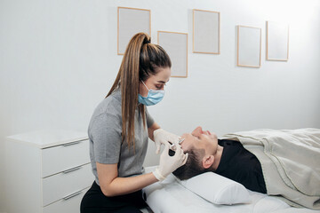 Master performs facial mesotherapy on a man