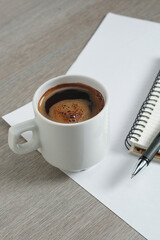 Coffee and notebook with pen
