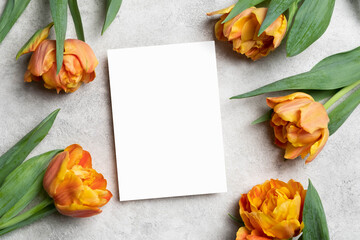 White card mockup with copy space, blank invitation or greeting card mock up with tulips flowers