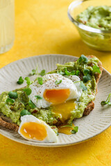 bruschetta with guacamole sauce and poached egg