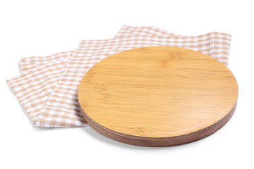 Round wooden cutting board and beige checkered napkin on white background