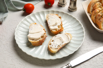 Plate of tasty bruschetta with processed cheese and fresh tomatoes on white background